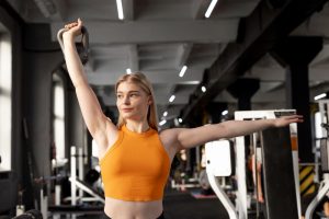 Medium shot woman training gym